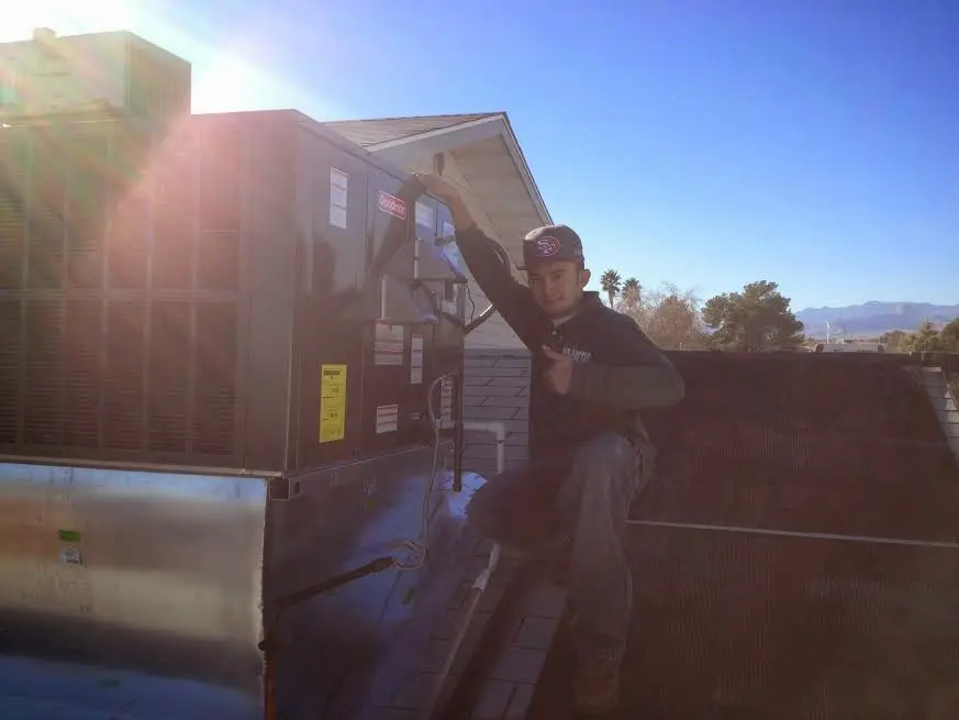 HVAC technician performing AC Tune-Up on a rooftop unit in Sudden Valley